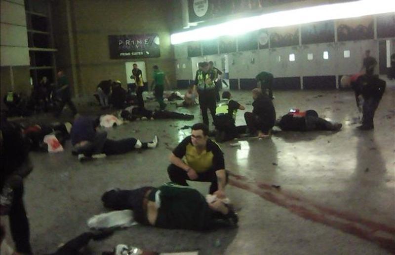 Helpers attend to injured people inside the Manchester Arena  Manchester  Britain  after a blast Monday  May 22  2017   An apparent suicide bomber attacked an Ariana Grande concert as it ended Monday night  killing over a dozen of people among a panicked crowd of young concertgoers   PA via AP 