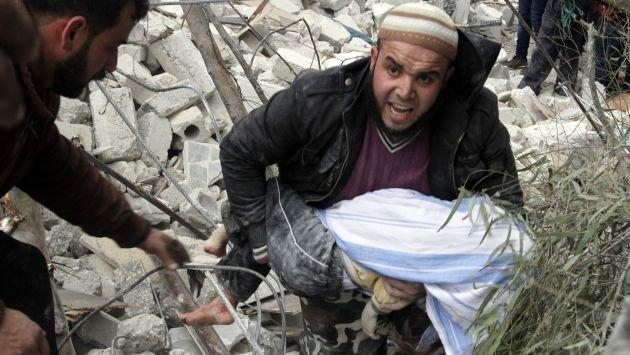 A Syrian man carries a child's body after a government airstrike hit the neighborhood of Ansari, in Aleppo, Syria, Sunday, Feb. 3, 2013.  The Britain-based activist group Syrian Observatory for Human Rights, which opposes the regime, said government troops bombarded a building in Aleppo's rebel-held neighborhood of Eastern Ansari that killed over 10 people, including at least five children. (AP Photo/Abdullah al-Yassin)