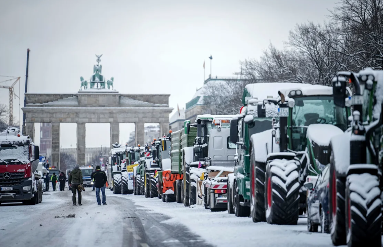 Agricultores protestan con tractores ante la Puerta de Brandemburgo en Berlín, Alemania. (Kay Nietfeld/dpa vía AP)